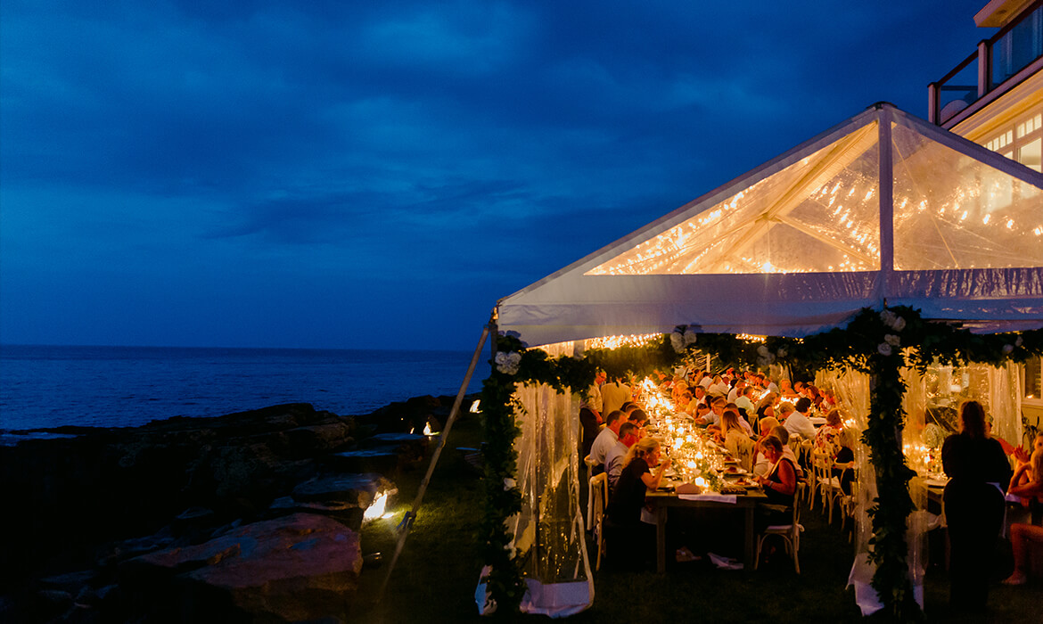 Bayview tent rental seen at nighttime with wedding reception