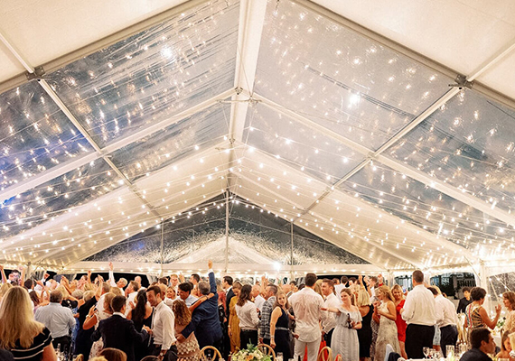 Bistro lights at wedding in tent rental