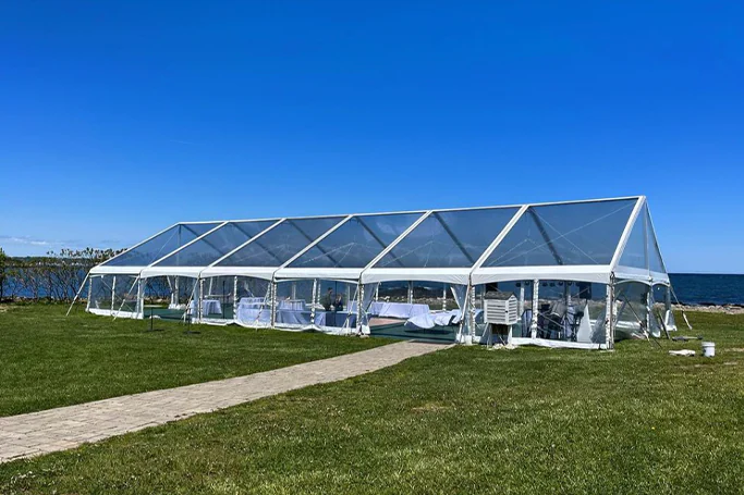 Full view of a clear wedding tent in the park