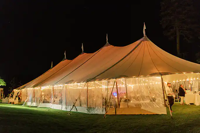wedding tent with lights at night time in New England