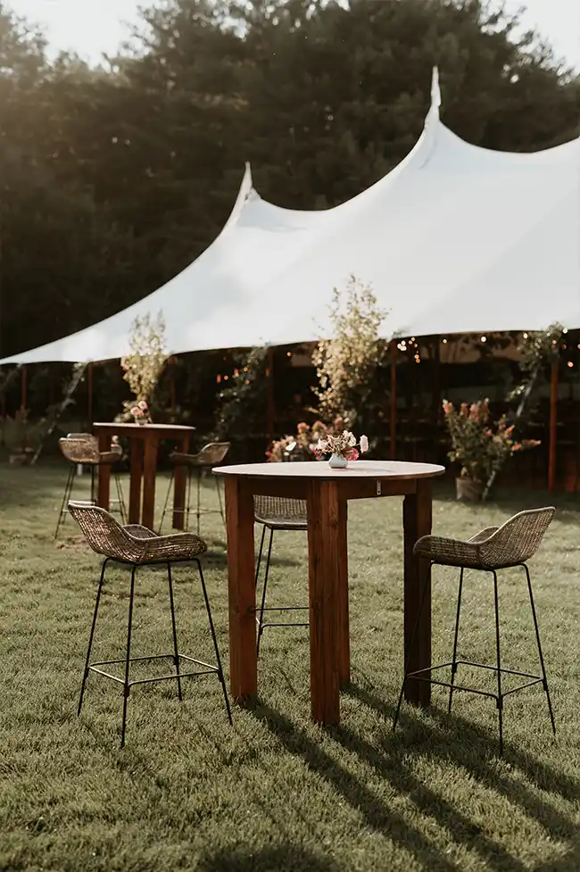 high table with chairs at wedding reception outdoors