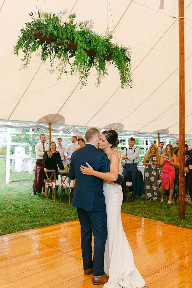 Newly wed couple dancing under a tent