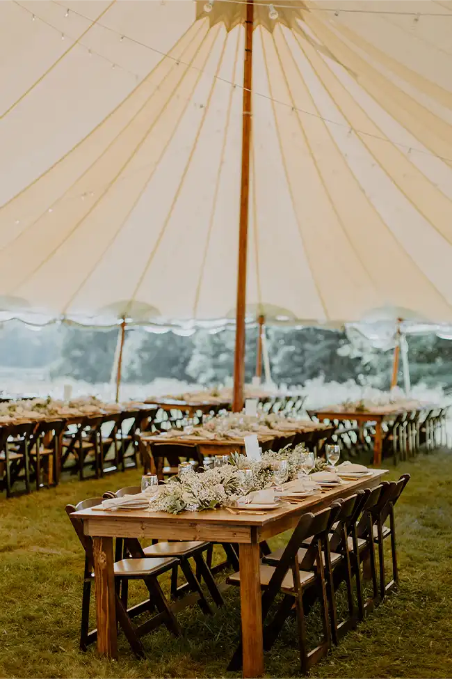 wedding tables under a Sperry tent